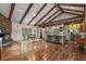 Spacious kitchen and dining area features a stone fireplace and wood floors at 2977 Glover Dr, Cumming, GA 30040