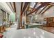 Open kitchen boasts wood beams, skylights, island, and modern appliances at 2977 Glover Dr, Cumming, GA 30040