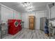 Spacious laundry room with modern red washer and dryer, ample storage, and stylish flooring, designed for efficiency at 2977 Glover Dr, Cumming, GA 30040