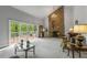 Inviting living room with stone fireplace, chandelier, large windows, and access to the outdoor deck at 2977 Glover Dr, Cumming, GA 30040