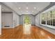 Bright living room with hardwood floors, large windows, and French doors leading to the outdoors at 2977 Glover Dr, Cumming, GA 30040