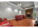 Living room featuring a brick fireplace, wood floors, and comfortable seating at 2977 Glover Dr, Cumming, GA 30040
