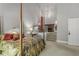 Cozy bedroom with a four-poster bed, elegant decor, and a fireplace visible from the stairs at 2977 Glover Dr, Cumming, GA 30040