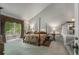 Spacious bedroom with a four-poster bed, window views, and adjacent staircase at 2977 Glover Dr, Cumming, GA 30040