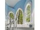 Beautiful staircase with large arched windows offering views of the surrounding trees at 2977 Glover Dr, Cumming, GA 30040
