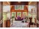 Cozy sunroom with wood walls, brick floors, and large windows providing natural light at 2977 Glover Dr, Cumming, GA 30040