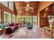 Bright sunroom with wood walls, brick floors, and multiple windows offering natural light at 2977 Glover Dr, Cumming, GA 30040