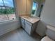 Bathroom featuring a modern vanity with stone countertop and window view at 623 Silva St # 130, Cumming, GA 30040