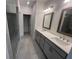 Primary bath featuring a double sink vanity with gray cabinets and a glass-enclosed shower at 623 Silva St # 130, Cumming, GA 30040