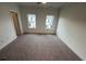 Bedroom with carpet flooring, bright lighting, and neutral colored walls ready for personalization at 623 Silva St # 130, Cumming, GA 30040