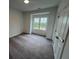 Bright bedroom with a large window and neutral carpet at 623 Silva St # 130, Cumming, GA 30040