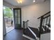Inviting entryway featuring dark wood floors and a staircase with modern black railings at 623 Silva St # 130, Cumming, GA 30040