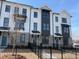 Modern townhome featuring painted brick, black trim, and a black metal fence at 623 Silva St # 130, Cumming, GA 30040