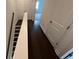 Hallway with dark floors leading to bedrooms with closet space at 623 Silva St # 130, Cumming, GA 30040