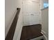 Hallway with beautiful hardwood floors and a double door closet at the top of the staircase at 623 Silva St # 130, Cumming, GA 30040