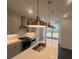 Bright kitchen showcasing stainless steel appliances, white cabinets, and a large island with sink at 623 Silva St # 130, Cumming, GA 30040