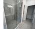 Modern bathroom featuring a glass shower enclosure with gray tile and built-in shower bench at 623 Silva St # 130, Cumming, GA 30040
