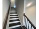 Clean white staircase with contrasting dark wood steps and railing at 623 Silva St # 130, Cumming, GA 30040