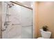 Elegant walk-in shower with glass door, marble-style tile, and dual shower heads at 12103 Windrush Ln, Alpharetta, GA 30009