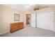 Comfortable bedroom with a dresser, closet, and a glimpse into the en-suite bathroom at 12103 Windrush Ln, Alpharetta, GA 30009