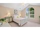 Serene bedroom with vaulted ceiling, large arched window, and cozy furnishings creating a relaxing atmosphere at 12103 Windrush Ln, Alpharetta, GA 30009