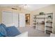 Bright bedroom with a daybed, vaulted ceiling, and closet, offering comfort and style at 12103 Windrush Ln, Alpharetta, GA 30009