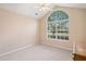 Inviting bedroom with a large window providing ample natural light, and soft carpet at 12103 Windrush Ln, Alpharetta, GA 30009