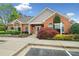 Beautiful brick clubhouse featuring manicured landscaping and clear signage at 12103 Windrush Ln, Alpharetta, GA 30009