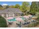 Relaxing community pool surrounded by lounge chairs and tables with umbrellas at 12103 Windrush Ln, Alpharetta, GA 30009