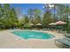 Large community pool with lots of space to relax in shaded lounge seating at 12103 Windrush Ln, Alpharetta, GA 30009