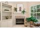 Close-up of a charming fireplace with tile surround and decorative mantle at 12103 Windrush Ln, Alpharetta, GA 30009