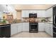 Bright kitchen featuring granite countertops, stainless appliances, and white cabinets, seamlessly connected to the dining area at 12103 Windrush Ln, Alpharetta, GA 30009