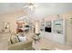 Bright living room featuring vaulted ceilings, a ceiling fan, and built-in shelving at 12103 Windrush Ln, Alpharetta, GA 30009