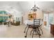 Open-concept living room with abundant natural light, vaulted ceilings, and seamless flow to the dining area at 12103 Windrush Ln, Alpharetta, GA 30009