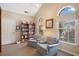 Reading room with lots of books and reading chairs next to bright window at 12103 Windrush Ln, Alpharetta, GA 30009