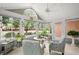 Bright sunroom with cathedral ceiling, large windows, and comfortable seating with a view of the green outdoors at 12103 Windrush Ln, Alpharetta, GA 30009