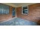 This back porch features brick siding, a window, and a wood framed screen door at 4222 Webb Rd, Tucker, GA 30084