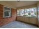 This back porch features brick siding and an open view of the yard with a window at 4222 Webb Rd, Tucker, GA 30084