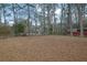 Large backyard with mature trees, shed, and fencing, offering privacy at 4222 Webb Rd, Tucker, GA 30084