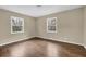 This bedroom features wood flooring, neutral colored walls, and natural light from the two windows at 4222 Webb Rd, Tucker, GA 30084