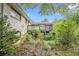 Backyard shot showcasing the house and a wood deck, with surrounding trees and green foliage, creating a private setting at 8600 Andy Mountain Ct, Villa Rica, GA 30180