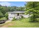 Well-kept one-story home with brick exterior, attached garage, and landscaped yard at 8600 Andy Mountain Ct, Villa Rica, GA 30180