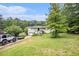 A charming brick ranch-style home with a spacious front yard and mature trees at 8600 Andy Mountain Ct, Villa Rica, GA 30180