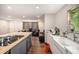 Open kitchen flows into the living area, featuring a butcher block island, and stainless appliances at 8600 Andy Mountain Ct, Villa Rica, GA 30180