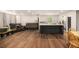 Bright living area with hardwood floors, a black island, comfortable seating, and natural light at 8600 Andy Mountain Ct, Villa Rica, GA 30180