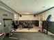 Finished basement features fitness equipment and ample space for activities and storage at 1902 Mack Rd, Douglasville, GA 30135