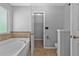 Bathroom suite with a soaking tub and walk-in closet at 4315 Summit Heights Dr, Snellville, GA 30039