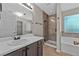 Bathroom suite features a tub and shower with modern tile work and finishes at 4315 Summit Heights Dr, Snellville, GA 30039
