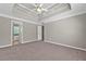 Bedroom featuring carpeted flooring, tray ceilings, and a bathroom en suite at 4315 Summit Heights Dr, Snellville, GA 30039