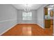 Bright dining room with hardwood floors, classic chandelier, and view into kitchen at 4315 Summit Heights Dr, Snellville, GA 30039